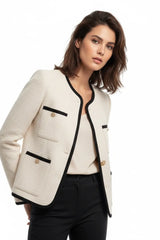 Elegant white women's blazer with black trim and gold buttons, chic and professional outfit